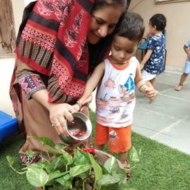 kid watering plant with teacher kindergarten mumslap.in