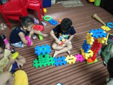 Kids building blocks, mum's lap.in